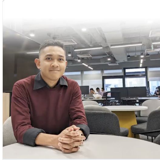 Nasrudin speaking at a desk in OCBC’s office